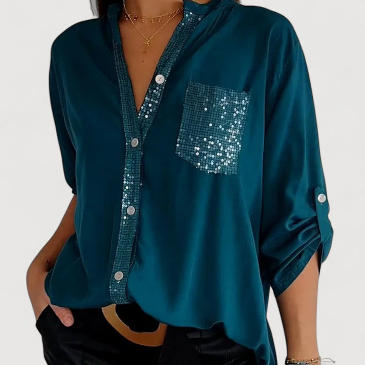 RENNA – BLUUS KIRKADE KANDIDEGA" could be rewritten as "RENNA – Bright Blue Blouse with Candles.